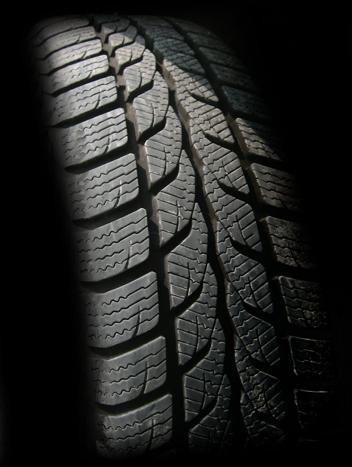 our-stories Detailed close-up image of a rubber tire showcasing texture and tread pattern, ideal for design concepts.